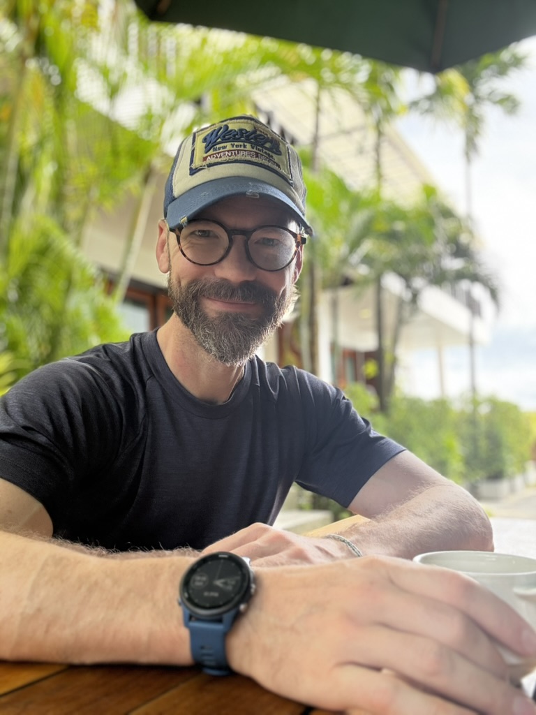 A relaxed portrait of Brendan Ellis sitting at a table