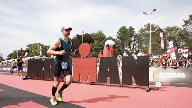 Brendan Ellis running through the finish area at Ironman Vichy